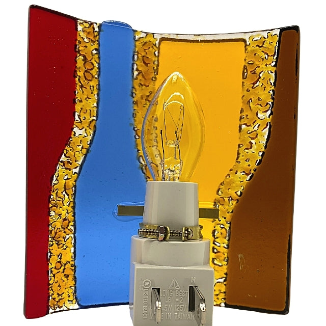This shows the back of the fused glass night light. It shows four wine bottles, two are upside down. They are four different colors; brown, yellow, blue & red. It is on a yellow background.