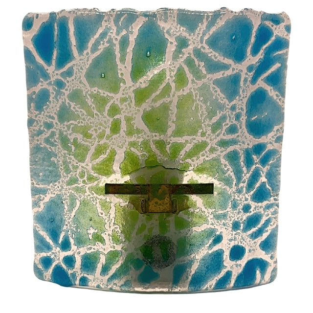 A fused glass night light. It shows a blue and green background with a crackling color of white.